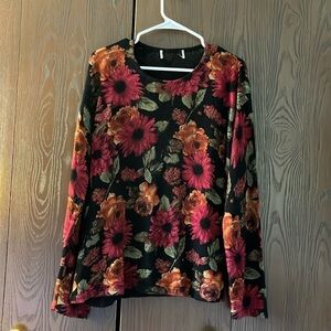 Tag removed black long sleeved sweater with floral pattern. Size Large